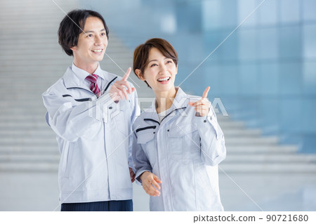 Male and female engineers in work clothes in the office Male and female engineers in work clothes in the office 90721680