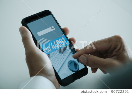 the text ISO 44001 in the screen of his smartphone 90722291