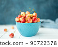 large ripe yellow pink cherries in a blue bowl 90722378
