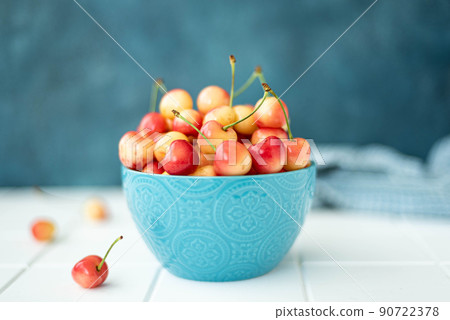 large ripe yellow pink cherries in a blue bowl large ripe yellow pink cherries in a blue bowl 90722378