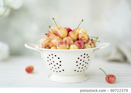 large ripe pink cherries in a white colander large ripe pink cherries in a white colander 90722379