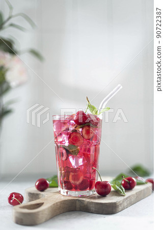 cocktail with cherry juice, mint, and ice in a glass cocktail with cherry juice, mint, and ice in a glass 90722387
