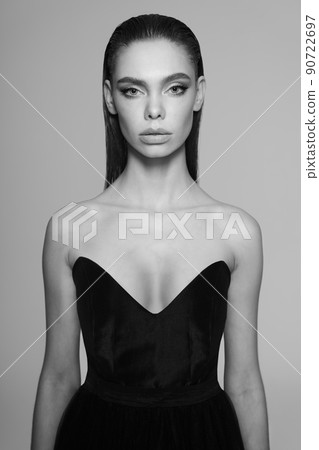 Beautiful woman pose in studio. Art portrait of a model in a black dress 90722697