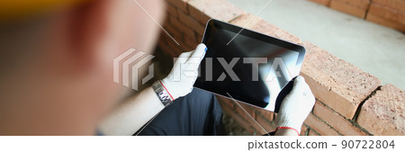 Construction worker holding tablet with black turned off screen 90722804