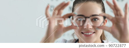 Woman eye doctor with eye test chart on background Woman eye doctor with eye test chart on background 90722877
