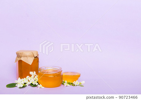 robinia honey bollte with acacia blossoms on colored table 90723466