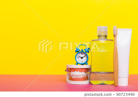 Mouthwash and other oral hygiene products on colored table top view with copy space. Flat lay. Dental hygiene. Oral care kit. Dentist concept 90723490