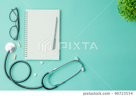 Glasses with a notebook and medical supplies. 90723554
