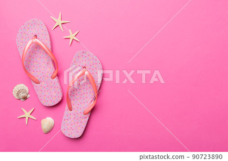 Flat lay composition with flip flops and seashell on colored background. Space for text top view Flat lay composition with flip flops and seashell on colored background. Space for text top view 90723890