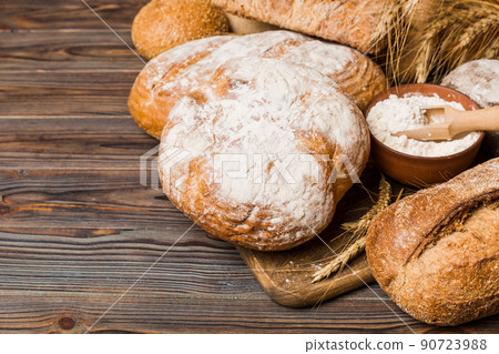 Homemade natural breads. Different kinds of fresh bread as background, perspective view with copy space Homemade natural breads. Different kinds of fresh bread as background, perspective view with copy space 90723988