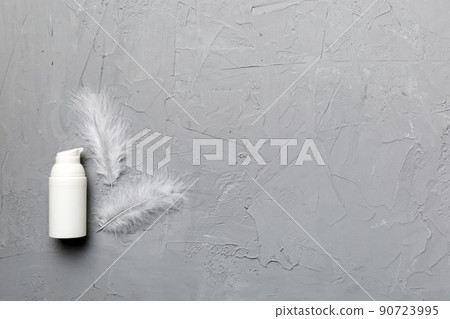 Set of skin care serums on pink pastel background with ostrich feathers. Spa cosmetic product, cream jar, branding mock up, top view with copy space 90723995