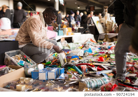African American man chooses antiques on the flea market African American man chooses antiques on the flea market 90724194