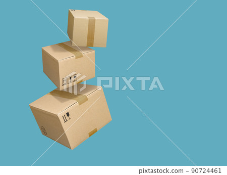 Cardboard parcel boxes falling on turquoise blue background Cardboard parcel boxes falling on turquoise blue background 90724461