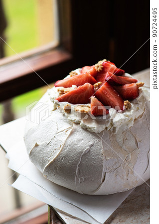 Pavlova - summer fresh fruit dessert near the window. 90724495