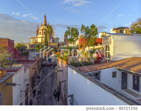 Aerial Drone Shot From Narrow street in San Miguel de Allende Cathedral at evening light in Guanajuato, Mexico 90725356