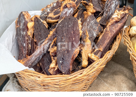 Pieces of homemade beef jerky in basket at farmers market. Close-up on tasty jerky meat snack. Pieces of homemade beef jerky in basket at farmers market. Close-up on tasty jerky meat snack. 90725509