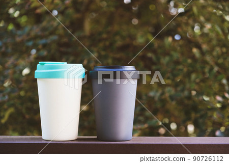 Reusable eco friendly bamboo cups against green summer nature background. Reusable eco friendly bamboo cups against green summer nature background. 90726112
