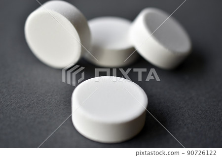 White large round tablets on a gray background. Medicines. White large round tablets on a gray background. Medicines. 90726122