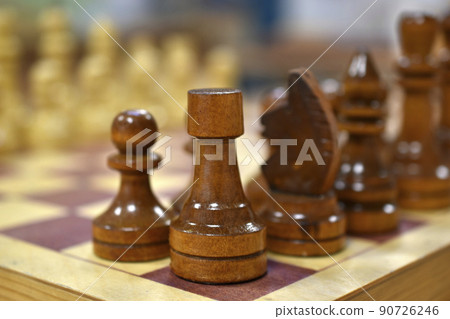 Chessboard with wooden pieces black and white Chessboard with wooden pieces black and white 90726246
