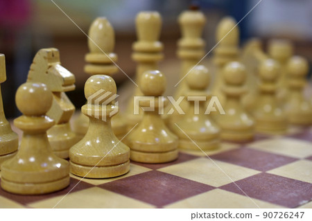 Chessboard with wooden pieces black and white Chessboard with wooden pieces black and white 90726247