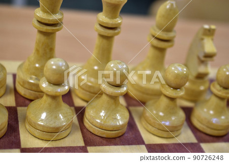 Chessboard with wooden pieces black and white Chessboard with wooden pieces black and white 90726248