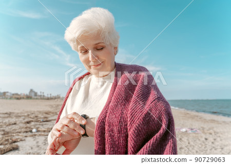 Elderly lady checking the heart rate after walking Elderly lady checking the heart rate after walking 90729063