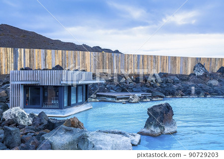 Cabin at natural geothermal spa surrounded by fence against cloudy sky Cabin at natural geothermal spa surrounded by fence against cloudy sky 90729203