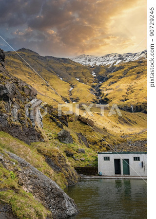Idyllic view of Seljavallalaug hotspring pool against mountains during sunset Idyllic view of Seljavallalaug hotspring pool against mountains during sunset 90729246