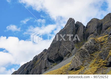 Low angle view of rock formations on volcanic landscape against blue sky 90729252