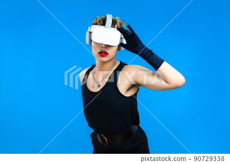 asian gay man with VR glasses posing isolated blue color background, Metaverse and Pride month Concept 90729338