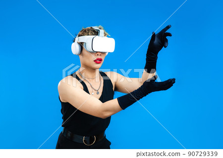asian gay man with VR glasses isolated blue color background, People emotions, Metaverse and Pride month Concept asian gay man with VR glasses isolated blue color background, People emotions, Metaverse and Pride month Concept 90729339