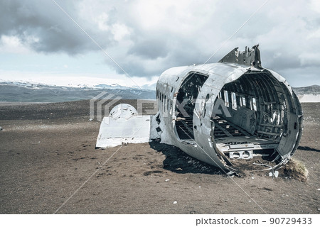 Broken military aircraft wreck at black sand beach in Solheimasandur against sky 90729433