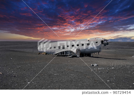 Broken military plane wreck at black sand beach in Solheimasandur at sunset 90729454