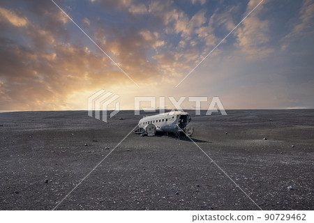Broken military airplane wreck at famous beach in Solheimasandur in sunset Broken military airplane wreck at famous beach in Solheimasandur in sunset 90729462