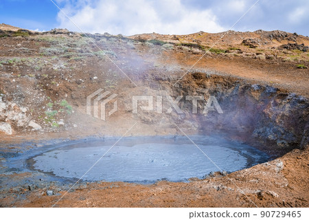 View of geothermal mud spot amidst landscape in Hveragerdi valley on sunny day 90729465