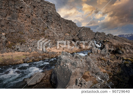 Beautiful Drekkingarhylur amidst rocky cliffs at Thingvellir National Park 90729640