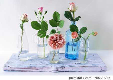 Fresh pink roses in glass transparent vases, flowers for romantic greetings, happy birthday, invitations, postcard 90729743