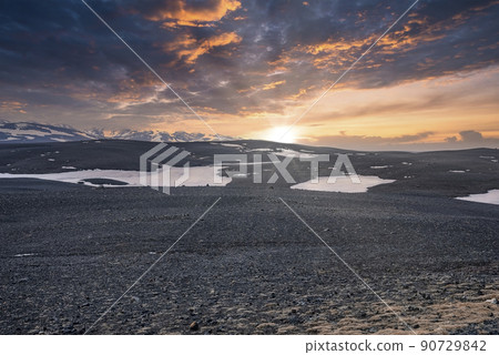 Scenic view of sun shining over snow on volcanic landscape during sunset Scenic view of sun shining over snow on volcanic landscape during sunset 90729842