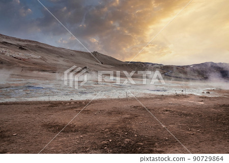 View of steam emitting from crater in geothermal area of Hverir during sunset View of steam emitting from crater in geothermal area of Hverir during sunset 90729864