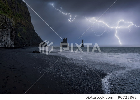 Idyllic view of lightning at black Reynisfjara Beach against stormy night Idyllic view of lightning at black Reynisfjara Beach against stormy night 90729865