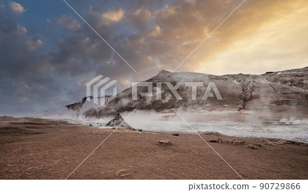 Steam emitting from crater in geothermal area of Hverir against sky during sunset Steam emitting from crater in geothermal area of Hverir against sky during sunset 90729866