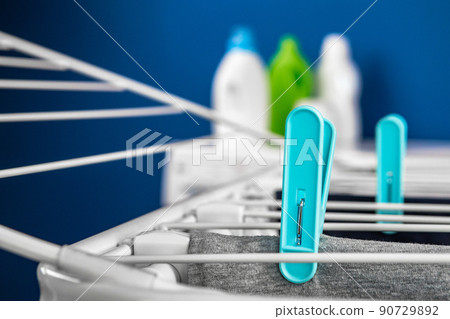 Clothes hanger rack dryer with clothespins close up Clothes hanger rack dryer with clothespins close up 90729892