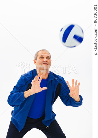 Old athlete in blue tracksuit plays with ball on white background Old athlete in blue tracksuit plays with ball on white background 90730001