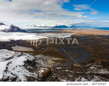 Aerial view of the glaciers and snowy mountains in Iceland. Aerial view of the glaciers and snowy mountains in Iceland. 90730487