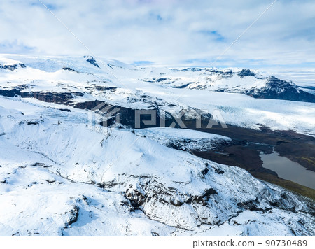 Aerial view of the glaciers and snowy mountains in Iceland. Aerial view of the glaciers and snowy mountains in Iceland. 90730489