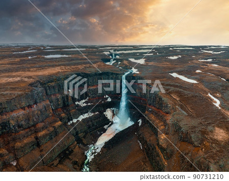 Aerial view on Hengifoss waterfall with red stripes sediments in Iceland. 90731210