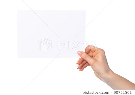Woman's hand holding blank white sheet of paper isolated on white 90731561