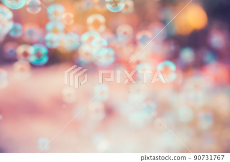 Abstract blurred of rainbow soap bubbles from the bubble blower flying on green grass. spring or summer season background. symbol of childhood. bokeh background. Abstract blurred of rainbow soap bubbles from the bubble blower flying on green grass. spring or summer season background. symbol of childhood. bokeh background. 90731767