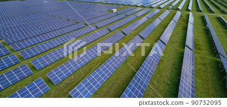 Aerial view of big sustainable electric power plant with many rows of solar photovoltaic panels for producing clean electrical energy. Renewable electricity with zero emission concept Aerial view of big sustainable electric power plant with many rows of solar photovoltaic panels for producing clean electrical energy. Renewable electricity with zero emission concept 90732095