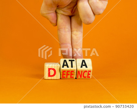 Data defence symbol. Concept words Data defence on wooden cubes. Beautiful orange table orange background. Businessman hand. Business and cyber crime concept. Copy space. 90733420